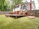 Outdoor space featuring a wooden deck, brick foundation, and grassy backyard at 318 Chestnut Ave, Kannapolis, NC 28081