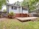 Exterior view of wooden deck, brick foundation, and fenced in backyard at 318 Chestnut Ave, Kannapolis, NC 28081