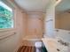Clean bathroom with shower-tub combo and a single window to let in natural light at 318 Chestnut Ave, Kannapolis, NC 28081
