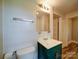 Cozy bathroom featuring a green vanity and white fixtures at 318 Chestnut Ave, Kannapolis, NC 28081