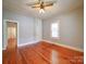 Bedroom showcasing hardwood floors, built-in storage, and a window at 318 Chestnut Ave, Kannapolis, NC 28081