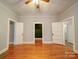 Spacious bedroom with gleaming hardwood floors and multiple entry points at 318 Chestnut Ave, Kannapolis, NC 28081