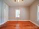 Well-lit bedroom featuring hardwood floors, natural light, and built-in storage at 318 Chestnut Ave, Kannapolis, NC 28081