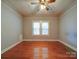 Bright bedroom featuring hardwood floors, neutral walls, and a ceiling fan at 318 Chestnut Ave, Kannapolis, NC 28081