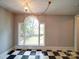 Charming dining room with beautiful arched window, and black and white checkered flooring at 318 Chestnut Ave, Kannapolis, NC 28081