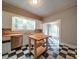 View of the kitchen with an island workstation with black and white tile floor at 318 Chestnut Ave, Kannapolis, NC 28081