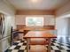 Bright kitchen features stainless steel appliances, butcher block counters, and black and white tile flooring at 318 Chestnut Ave, Kannapolis, NC 28081