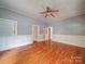 Hardwood floors and trim highlight this living room with an attached built-in bookcase and multiple entrances at 318 Chestnut Ave, Kannapolis, NC 28081