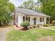 Exterior view of the house with a chimney, green lawn, and wooden shutters at 318 Chestnut Ave, Kannapolis, NC 28081