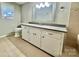 Bathroom with a long vanity, white cabinets, stylish mirror, and neutral tile flooring at 35 Caldwell Dr, Taylorsville, NC 28681