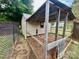 Exterior shot of a chicken coop area with fenced enclosure in a grassy yard at 35 Caldwell Dr, Taylorsville, NC 28681