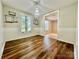 Dining room featuring hardwood floors, modern light fixture, and decorative shelving at 35 Caldwell Dr, Taylorsville, NC 28681