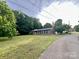 Cozy brick ranch home featuring mature trees and a well-kept lawn at 35 Caldwell Dr, Taylorsville, NC 28681