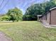 Expansive front yard with mature trees and a view of the home's welcoming porch at 35 Caldwell Dr, Taylorsville, NC 28681