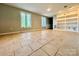 Bright living room with tile floors, large windows, and built-in bookshelves at 35 Caldwell Dr, Taylorsville, NC 28681