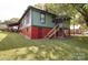 View of the backyard with a red brick base and a screened-in porch in the back of the home at 401 7Th St, Spencer, NC 28159