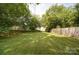 An expansive backyard features lush grass and mature trees at 401 7Th St, Spencer, NC 28159