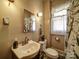 Cozy bathroom features a pedestal sink and a window that allows natural light in at 401 7Th St, Spencer, NC 28159