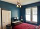 Bedroom boasts hardwood floors, great natural light, and stylish light fixture at 401 7Th St, Spencer, NC 28159