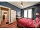 Comfortable bedroom has a wooden bed frame, hardwood floors, and natural lighting at 401 7Th St, Spencer, NC 28159