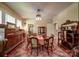 Elegant dining room with hardwood floors, vintage furniture and a decorative rug at 401 7Th St, Spencer, NC 28159