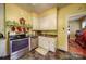 Functional kitchen with retro yellow walls, stainless steel appliances, and tile floor at 401 7Th St, Spencer, NC 28159