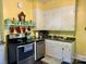 Efficient kitchen featuring white cabinets, stainless appliances, and yellow accents at 401 7Th St, Spencer, NC 28159