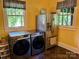 Convenient laundry area featuring a stainless refrigerator, washer, and dryer at 401 7Th St, Spencer, NC 28159