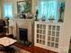 Charming living room featuring a brick fireplace and decorative nautical-themed elements at 401 7Th St, Spencer, NC 28159