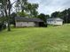Lush backyard featuring well-maintained grass, back porch, and mature shade trees at 405 Jose St, Shelby, NC 28150