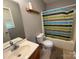 Bathroom with a colorful shower curtain, functional toilet, and modern vanity at 405 Jose St, Shelby, NC 28150