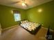Bright bedroom featuring green walls, plush carpeting, and a window with natural light at 405 Jose St, Shelby, NC 28150