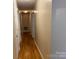 Long hallway featuring hardwood floors and doors leading to various rooms at 405 Jose St, Shelby, NC 28150