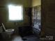 Bathroom with a window, toilet, and damaged wall and floor at 421 W Cemetery St, Salisbury, NC 28144