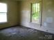 An empty bedroom showcases hardwood floors and natural light streaming through the windows at 421 W Cemetery St, Salisbury, NC 28144