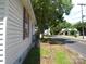 Exterior view showing a house with yellow siding, maroon shutters, and overgrown foliage at 421 W Cemetery St, Salisbury, NC 28144
