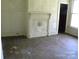 Living room with a faux fireplace, wall paneling, hardwood floors, and a window at 421 W Cemetery St, Salisbury, NC 28144