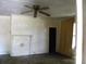 Living room with a ceiling fan, a faux fireplace, wall paneling, and hardwood floors at 421 W Cemetery St, Salisbury, NC 28144