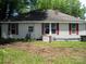 Rear of the house, showing white siding, red shutters, and a cleared yard at 421 W Cemetery St, Salisbury, NC 28144