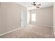 Comfortable bedroom with neutral walls, plush carpeting, a ceiling fan, and a window at 4352 Haddington Dr, Fort Mill, SC 29707