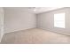 Spacious bedroom featuring neutral paint, plush carpeting, a ceiling fan, and a large window at 4352 Haddington Dr, Fort Mill, SC 29707
