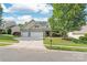 Charming two-story home with a three-car garage, lush lawn, and mature trees at 4352 Haddington Dr, Fort Mill, SC 29707