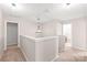 Upstairs hallway featuring neutral paint, carpet, lighting, and access to bedrooms and bathrooms at 4352 Haddington Dr, Fort Mill, SC 29707