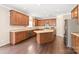 Spacious kitchen features wood cabinets, stainless steel appliances, and large island with dark wood flooring at 4352 Haddington Dr, Fort Mill, SC 29707