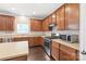 Charming kitchen showcases wood cabinets, modern appliances, and countertops with a window that brings in natural light at 4352 Haddington Dr, Fort Mill, SC 29707