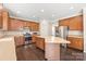 A modern kitchen with stainless steel appliances, wooden cabinets, and a kitchen island for extra counter space at 4352 Haddington Dr, Fort Mill, SC 29707