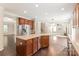 Open kitchen with a center island overlooks the carpeted living room, stainless steel fridge and wood floors at 4352 Haddington Dr, Fort Mill, SC 29707