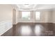 Bright, airy room with crown molding, paneled walls, hardwood floors, and large windows at 4352 Haddington Dr, Fort Mill, SC 29707