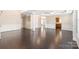 Elegant living room with dark hardwood floors, decorative pillars, and open layout to kitchen at 4352 Haddington Dr, Fort Mill, SC 29707