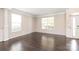Spacious room featuring hardwood floors, crown molding, and large windows at 4352 Haddington Dr, Fort Mill, SC 29707